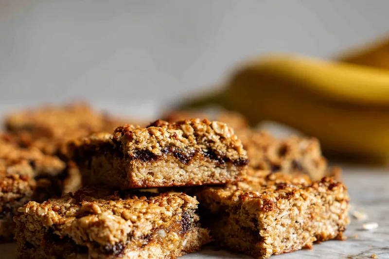 Freshly baked banana oat bars cooling on a rack