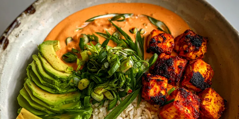 Delicious Creamy Golden Chicken and Avocado Rice Bowl served on a plate