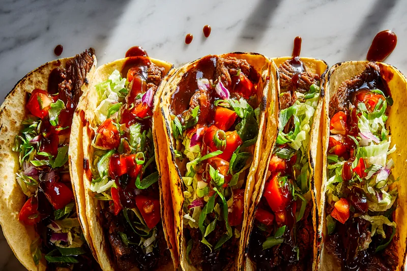Cooking Garlic Butter Honey BBQ Beef in a skillet with garlic and spices.