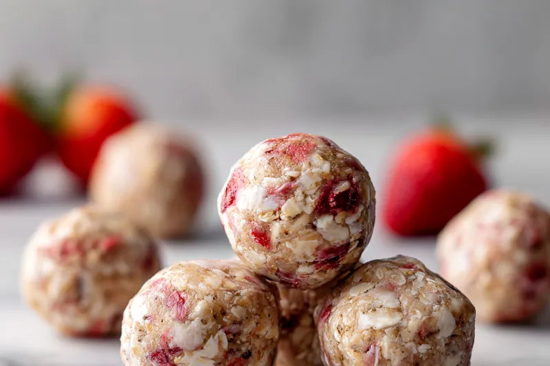 Mixing ingredients for no-bake strawberry cheesecake protein balls
