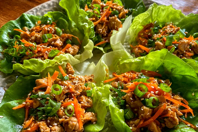 Chef Mitchell cooking chicken for Zesty Thai Chicken Wraps in a hot skillet.