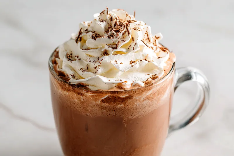 Ingredients for whipped hot chocolate including milk and chocolate